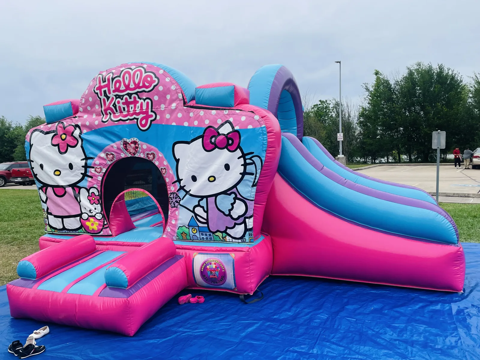 Pink themed castle bounce house at a party